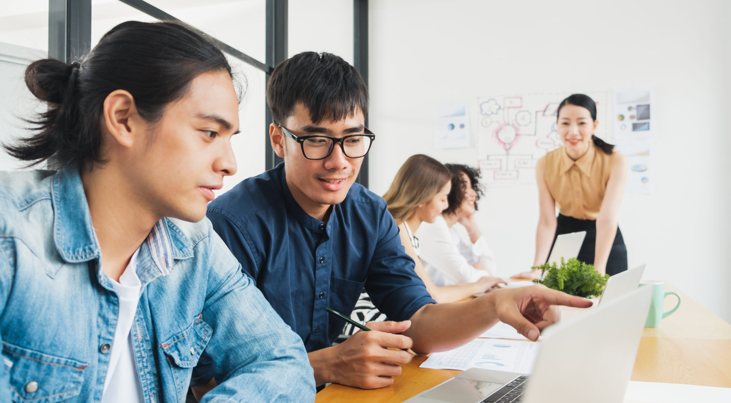 Asian business people working with laptop, searching data for business startup plan and strategy Asian business people working with laptop, searching data for business startup plan and strategy