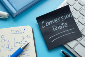 Black post-it note reads "Conversion Rate" in white chalk.
